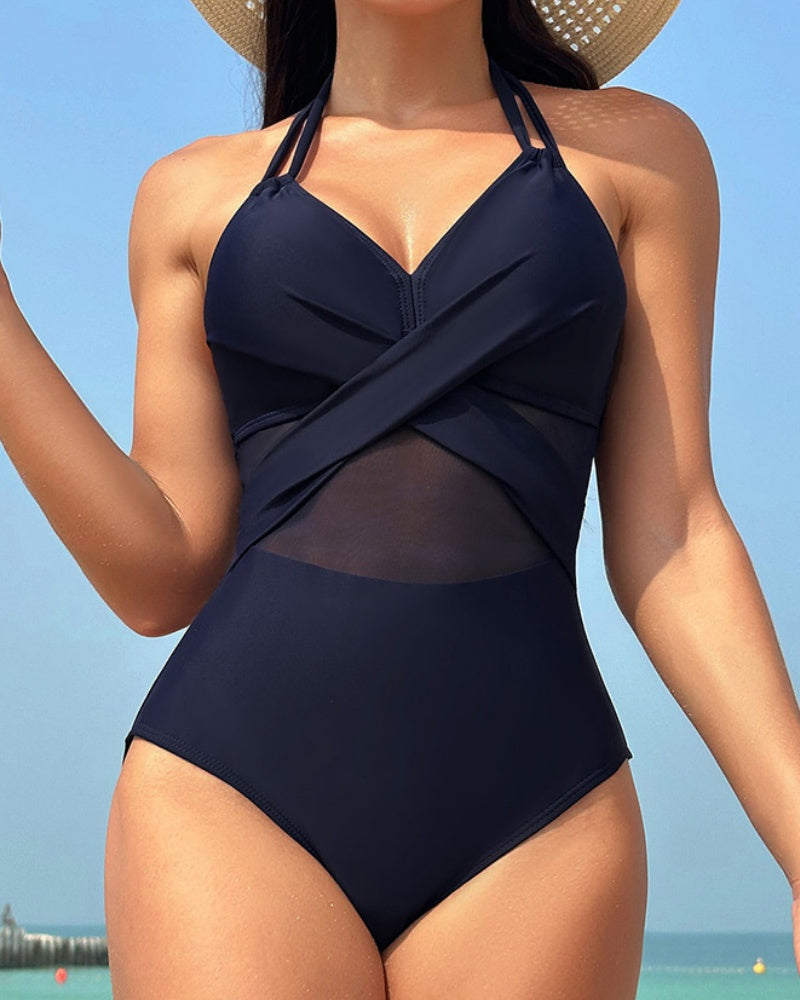 Traje de baño de una pieza con cuello halter y aplicación de malla y tirantes dobles y frente cruzado.